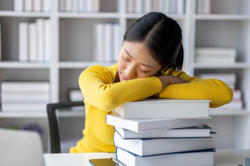 Wall Mural - Asian teenage woman sitting in white office with laptop, she is a student studying online with laptop at home, university student studying online, online web education concept.