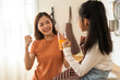 © Art_Photo - Portrait of enjoy happy love asian family mother with little asian girl preparing drinking glass of fresh juice and orange on counter in kitchen at home.Diet concept.healthy drink