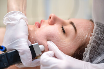 Wall Mural - Closeup of female patient during rejuvenation procedure performed by a professional beautician in a beauty clinic