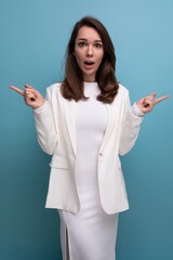 Wall Mural - portrait of surprised shocked brunette woman in white dress with nice features