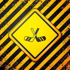 Poster - Black Ice hockey sticks icon isolated on yellow background. Warning sign. Vector