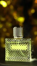 Vertical Video Of Glass Perfume Bottle Smoke Gold Bokeh