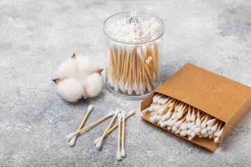 Sticker - Cotton buds in eco kraft packaging on a textured background. Cotton swab on a white background. Sticks for hygiene of the nose and ears. Bamboo cotton buds. Eco friendly.Place for text.Space for copy.