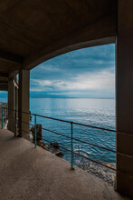 Lovran Promenade And Coastline, View Of Adriatic Sea And Kvarner Gulf On Cold Overcast Day With Stormy Clouds At Sky