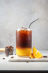 Wall Mural - Bumble coffee mix with orange juice and cold brew coffee with ice. Summer trendy refreshing coffee drink.