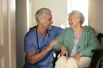 Wall Mural - Caregiver doing regular check-up of senior woman in her home.