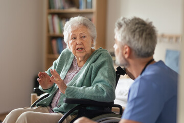 Wall Mural - Caregiver doing regular check-up of senior woman in her home.