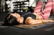 © Alejandro - young latin woman with long hair lying on mat, doing relaxing exercises, yoga pose and healthy lifestyle, routine in sportswear