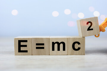 Wall Mural - the albert einstein physics equation is e equals m c squared in a wooden block of dice. physics educ