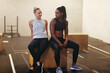 © Flamingo Images - Two fit woman smiling after a box jump workout