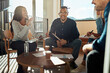 © Flamingo Images - Diverse office coworkers laughing together during a meeting