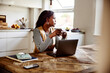 © Flamingo Images - Businesswoman drinking coffee in her kitchen