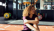 © Flamingo Images - Fit woman sitting on a gym floor