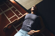 © Flamingo Images - Woman lying on a gym floor after a workout