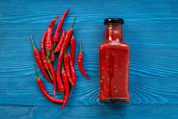 Sticker - Bottle of spicy sauce tabasco with red hot chili pepper, top view