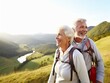 © mashimara - Happy elderly senior couple hiking in the mountains together, enjoying life