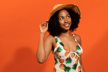 Wall Mural - Cute relaxed black woman wearing swimsuit and straw hat