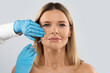 © Prostock-studio - Beautiful middle aged woman getting cosmetic injection in nasolabial folds