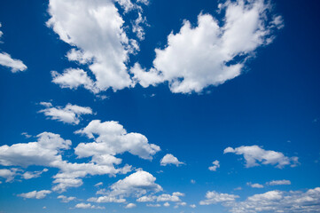 White clouds against a blue sky background