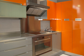 Wall Mural - New modern kitchen in orange with metal