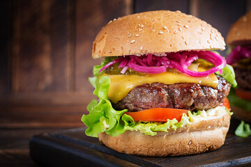 Wall Mural - Beef hamburger. Sandwich with beef burger, tomatoes, cheese, pickled cucumber and lettuce. Cheeseburger.