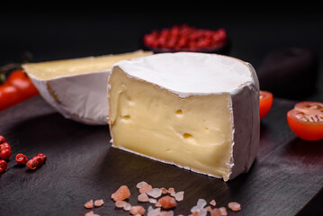 Delicious fresh brie cheese in the form of a mini head with cherry tomatoes