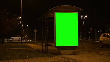 Wall Mural - City street bus stop advertising billboard green screen mockup at night