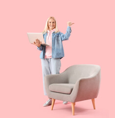 Poster - Mature female programmer with laptop pointing at something on pink background