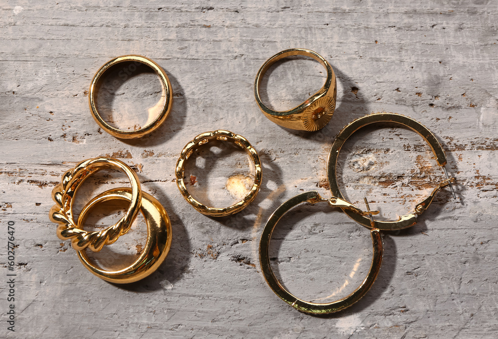 Different beautiful jewellery on grey wooden background