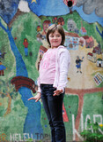 Fototapeta  - happy young girl posing and jumping with abstract urban style painting bacground begind