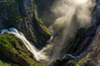 Amazing sunbeams passing through the mist created by the Voringfossen  waterfalls, Norway