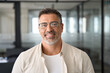 © Stock 4 You - Headshot close up portrait of latin confident mature good looking indian middle age leader, ceo male businessman on blur office background. Handsome hispanic senior business man smiling at camera.
