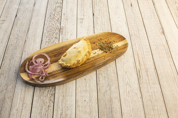 Wall Mural - A delicious unit of empanada stuffed with chicken with red onion