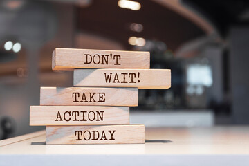 Wall Mural - Wooden blocks with words 'Don't wait, take action today'.