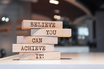 Wall Mural - Wooden blocks with words 'Believe you can achieve it'.