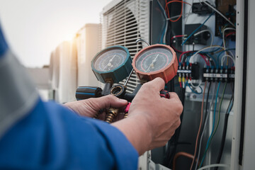 Technician is checking air conditioner,measuring equipment for filling air conditioners.