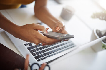 Woman, hands and office phone at a laptop for work networking and employee typing. Female worker, table and social network app with mobile communication and text for professional and web connection