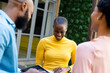 © Wavebreak Media - Smiling african american businesswomen and businessman using digital tablets while standing outdoors