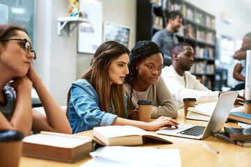 Laptop, library and university girl students studying together for education in preparation of a test or exam. Computer, college and scholarship with female friends searching for information online