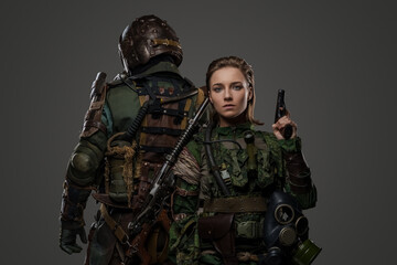photo of isolated on grey two female and male soldiers posing back to back.