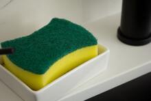 A View Of A Sponge On The Sink Counter.