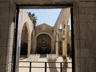 Wall Mural - roof less church San Giovanni Battista San Giovannello Giudecca district ortigia syracuse old buildings street view Sicily on sunny day