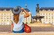 Woman tourist looking at bourse square in Bordeaux city- Tourism in France