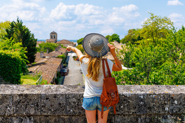 Wall Mural - woman tourist pointing blaye city view- france, nouvelle aquitaine