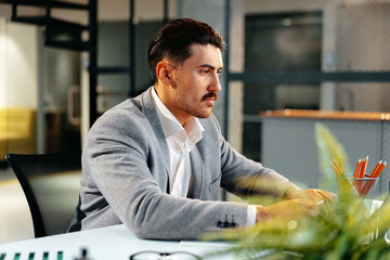 Poster - Young arab businessman working at the table in modern office