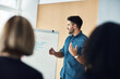 © Daniel Laflor/peopleimages.com - Presentation whiteboard, meeting speech and man training, coaching or teaching audience, trade show people or seminar. Event presenter, reading and male business leader talking to conference group