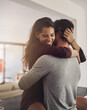 © A.S./peopleimages.com - Happy, couple and hug in home for love, romantic bond quality time for care together with partner. Young man, woman and hugging for romance of lovers in relationship, dating and smile for happiness