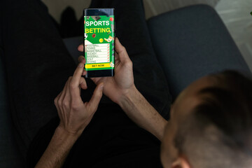 Businessman using smartphone against gambling app screen