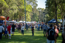 Weekend Country Market In A Park In Australia. Family’s And People At A Farmers Market Selling Fruit And Vegetables 