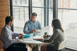 © Grady Reese/peopleimages.com - Meeting, documents and planning of business people in office teamwork, portfolio ideas and talking of project. Professional woman, men employees or clients listening, speaking and job collaboration